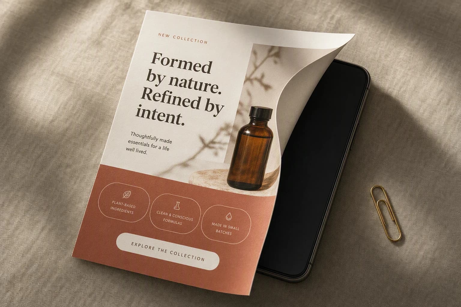 A printed sheet showing a polished ecommerce email design curling up off a smartphone whose screen underneath is completely blank